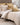A gold damask print duvet cover with oxford flange and satin stitch border.
